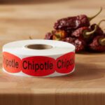 chipotle stickers on a roll of red labels with black print