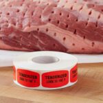 tenderized cook to 160 degrees sticker on a red label with black text