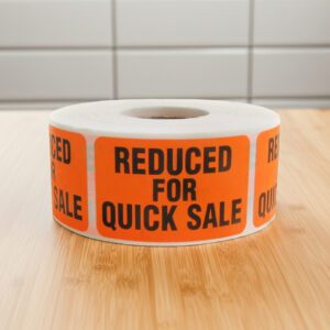 reduced for quick sale sticker on an orange rectangle label with black print