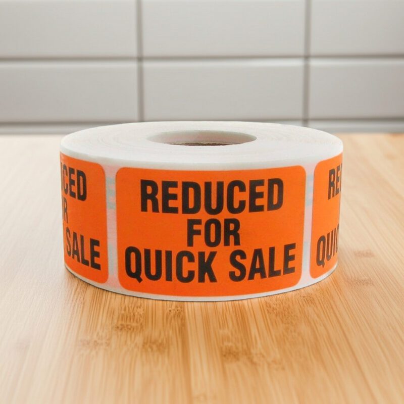 reduced for quick sale sticker on an orange rectangle label with black print