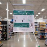 Ceiling Banner Display retractable sign with stabilizer for wide sign shown being pulled down