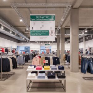 Ceiling Banner Display retractable sign with stabilizer in retail store
