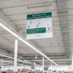 Ceiling Banner Display retractable sign with stabilizer for wide sign shown attached to ceiling