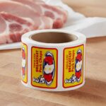 Breakfast Pork Chops Sticker on a roll of white rectangle labels with Yellow, Red and Blue Print showing a small man on a plate of pork chops