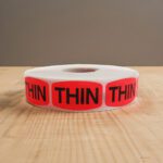 Thin sticker on a red label with black print