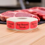 Top Round Steak Butcher sticker red identification label with black print on a roll of stickers