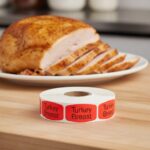 Turkey Breast sticker red identification label with black print on a roll of stickers with turkey in background